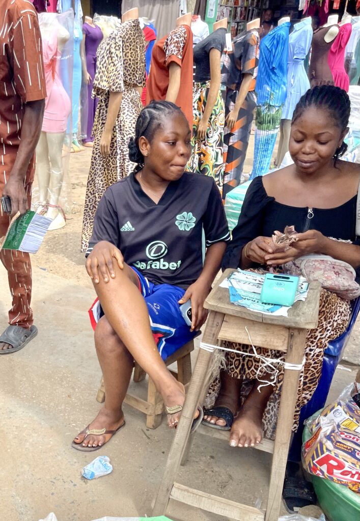 POS agent serving a customer in Nigeria, where card and transfer payments meet the online checkout